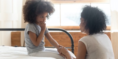 Mother talking to young daughter
