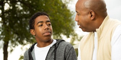 Father talking to teenage son